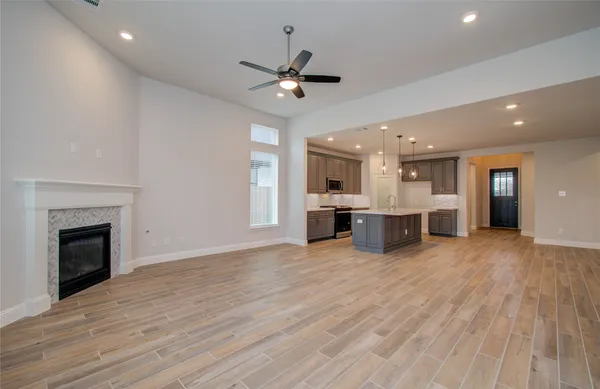 a kitchen with stainless steel appliances granite countertop a sink a stove oven a counter space and cabinets