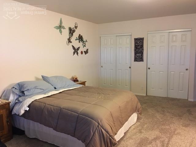 62637 Hawkview Road Bend, OR 97701 - Photo 13 of 19 a bedroom with a bed and a painting on the wall