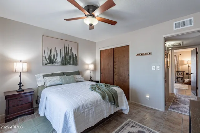a bedroom with a large bed and a chandelier