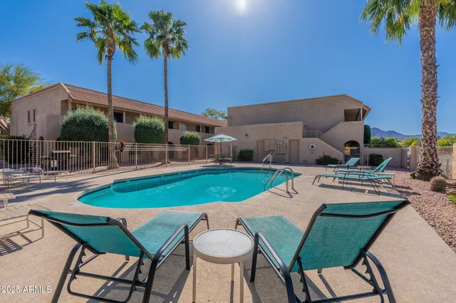 a view of a chairs and table in patio