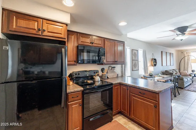 a kitchen with granite countertop stainless steel appliances and wooden cabinets