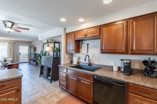 a kitchen with stainless steel appliances granite countertop sink stove and cabinets