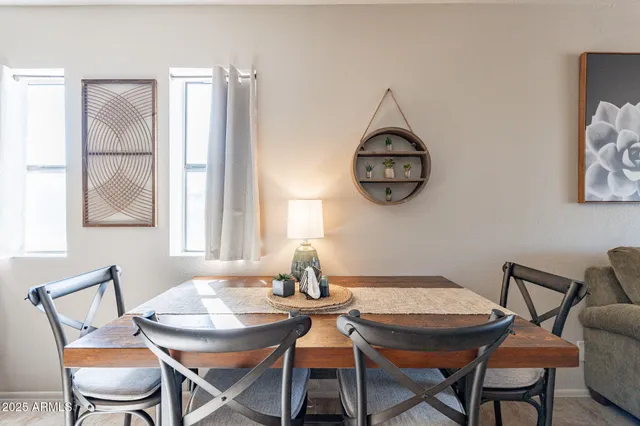 a dining room with furniture a rug and a window