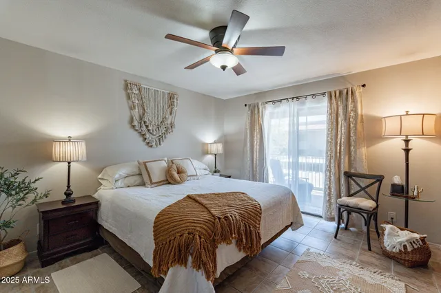 a bedroom with a bed and ceiling fan