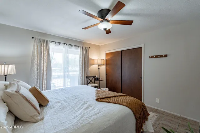 a bedroom with a large bed and a large window