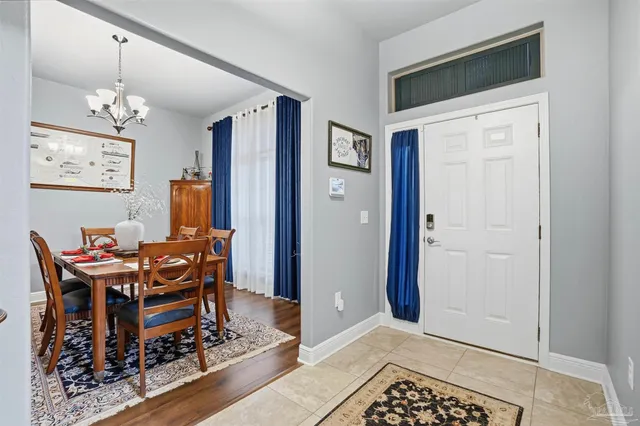 a view of a dining room with furniture and a chandelier