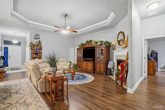 a living room with furniture a flat screen tv and a fireplace