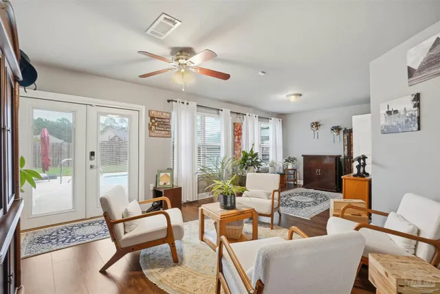 a living room with furniture a fireplace and a large window