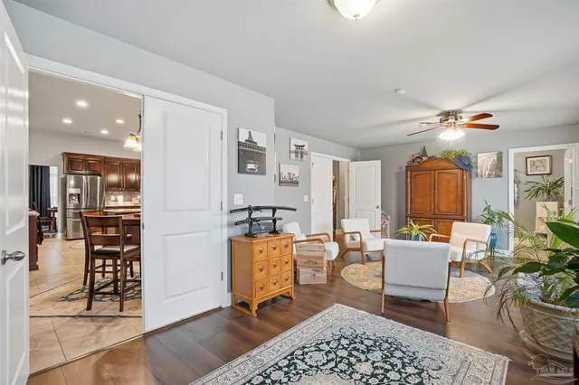 a living room with furniture a rug and kitchen view