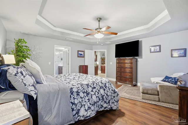 a bedroom with a bed and a television