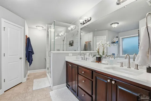 a spacious bathroom with a double vanity sink and a mirror