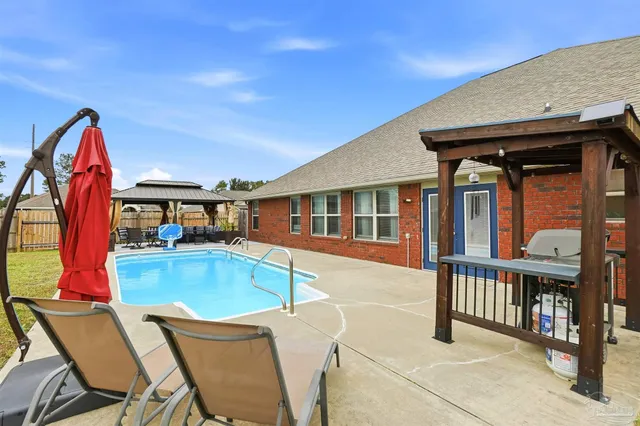 a view of a house with pool and porch