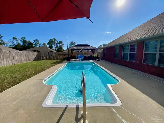 a view of a backyard with sitting area