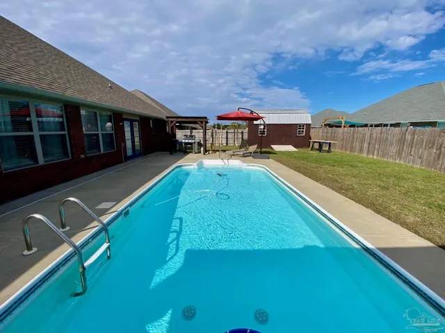 a view of a swimming pool with a deck