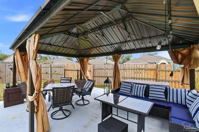 a view of a chairs and table in the balcony