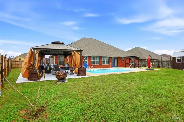 a view of a house with backyard porch and sitting area