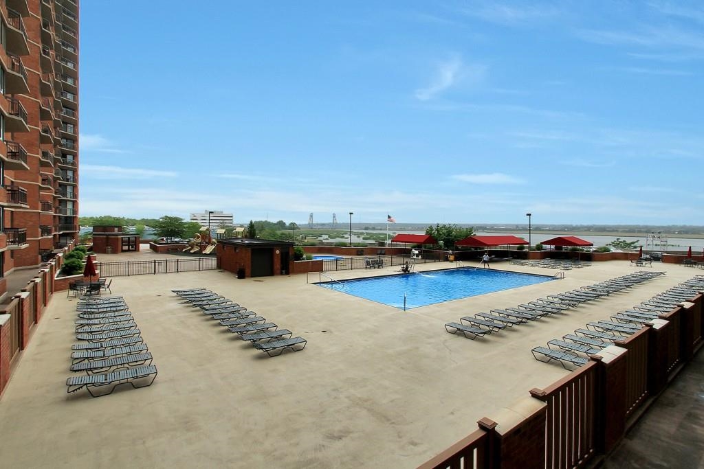 1908 Harmon Cove Tower, Unit 1908 Secaucus, NJ 07094 - Photo 27 of 49 a view of swimming pool with outdoor seating and city view