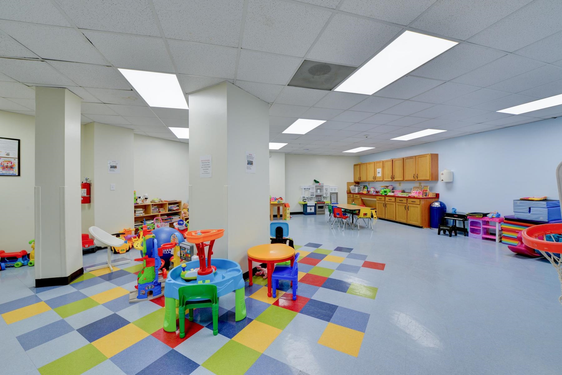 1908 Harmon Cove Tower, Unit 1908 Secaucus, NJ 07094 - Photo 47 of 49 a play room with toys and a play ground