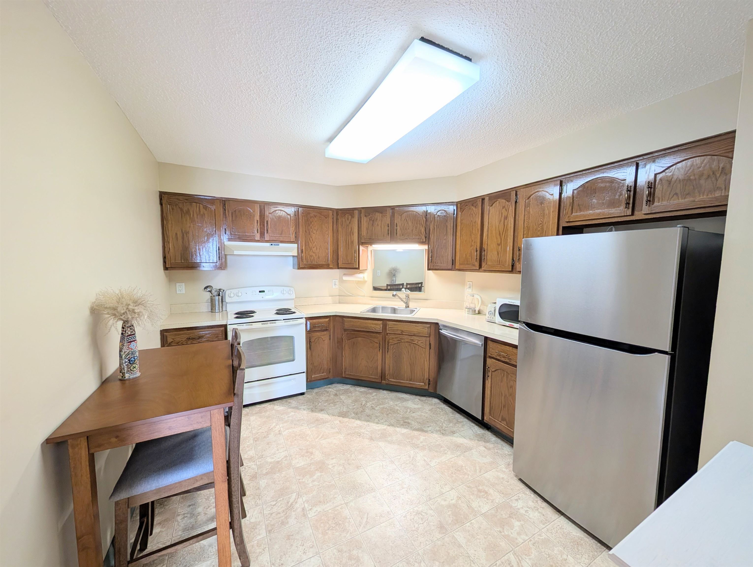 1908 Harmon Cove Tower, Unit 1908 Secaucus, NJ 07094 - Photo 8 of 49 a kitchen with a refrigerator a sink and dishwasher