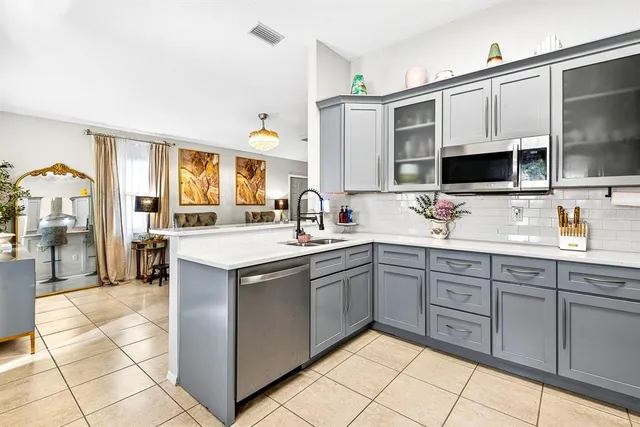 a kitchen with a sink appliances and cabinets