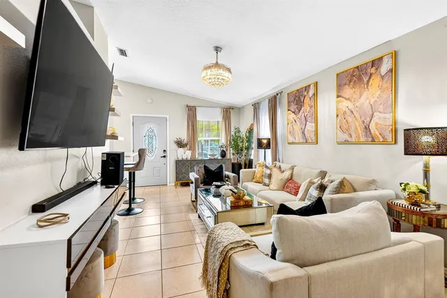 a living room with furniture and a flat screen tv
