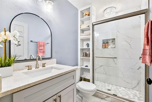 a bedroom with a bed lamp and a large window