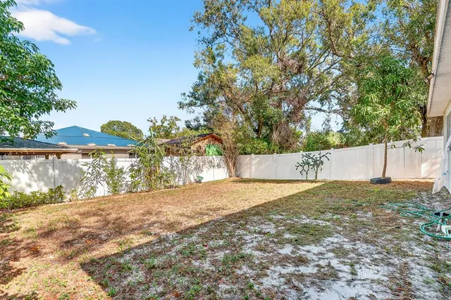 a front view of a house with yard and green space