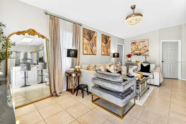 a living room with furniture a table and decor