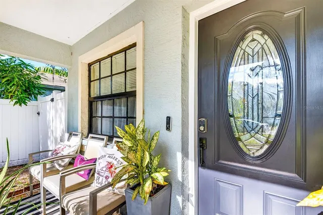 a living room with a mirror and furniture