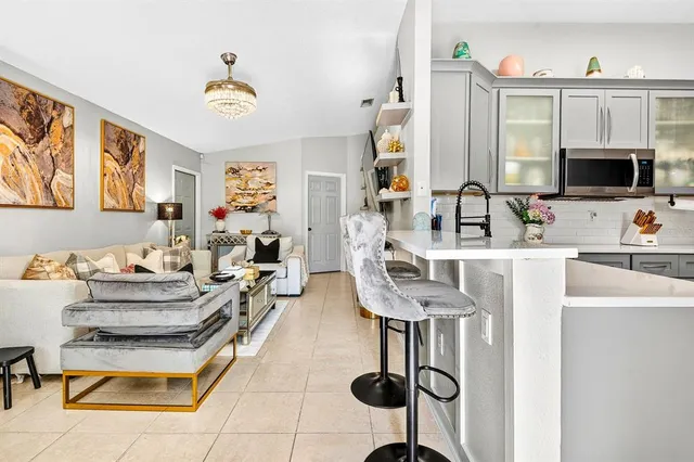 a kitchen with stainless steel appliances a refrigerator sink and microwave