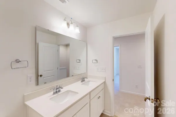 a bathroom with a sink double vanity and a mirror