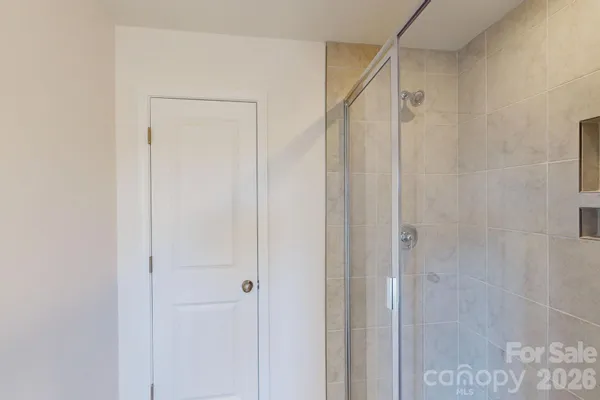 a bathroom with a shower and a glass door