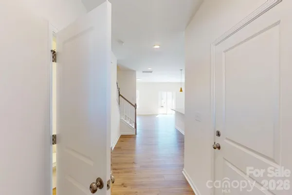 a view of a hallway with wooden floor