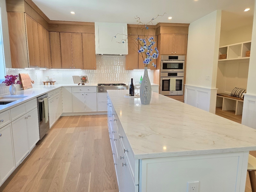 1 Danforth Drive Holliston, MA 01746 - Photo 13 of 42 a large kitchen with stainless steel appliances granite countertop a lot of counter space and wooden floors