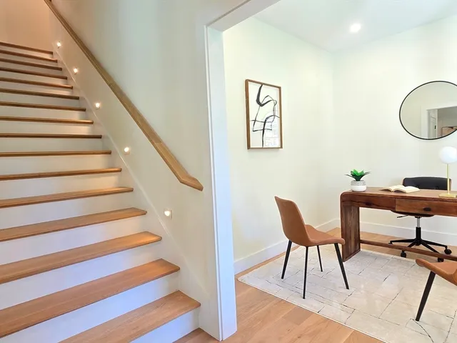 a workspace with furniture and stairs