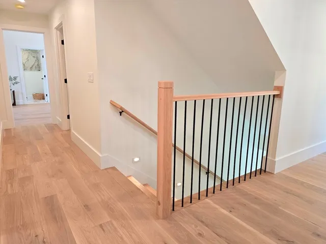 a view of a hallway with wooden floor and entryway