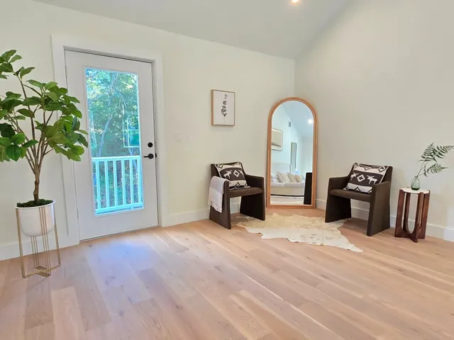 a view of a livingroom with furniture and a workspace