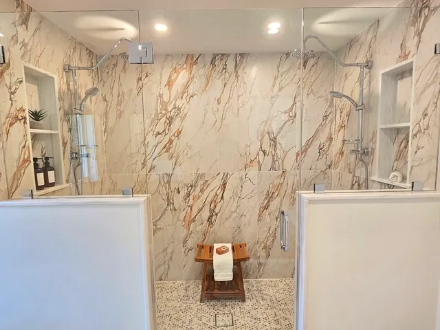 a bathroom with a bathtub and shower