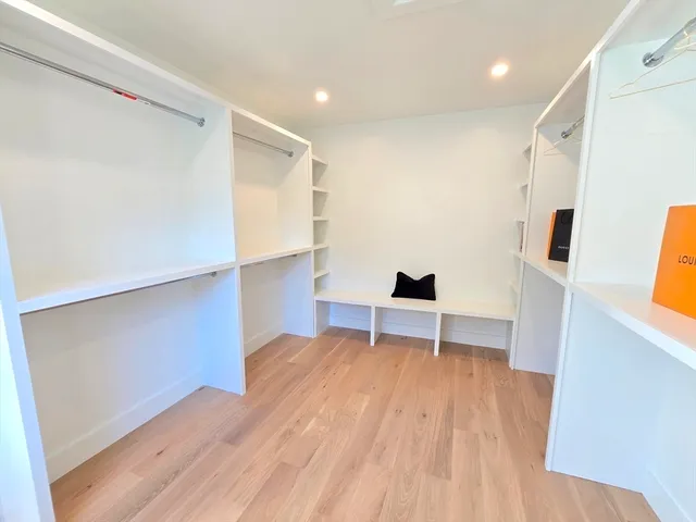 a view of room with wooden floor and furniture