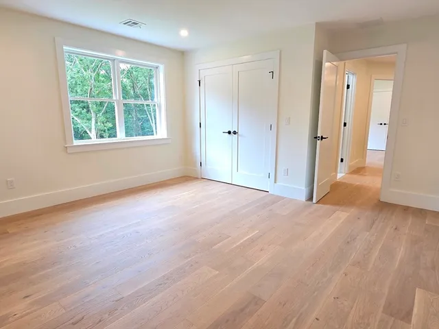 a view of a livingroom with wooden floor and window