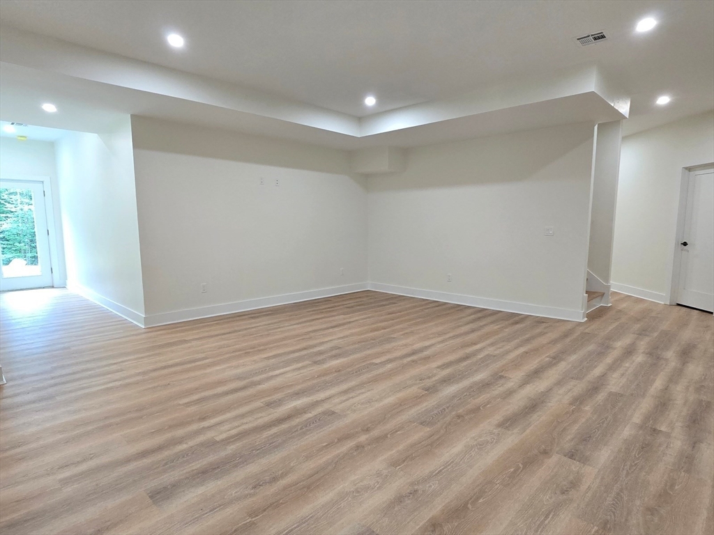 1 Danforth Drive Holliston, MA 01746 - Photo 37 of 42 an empty room with wooden floor and windows