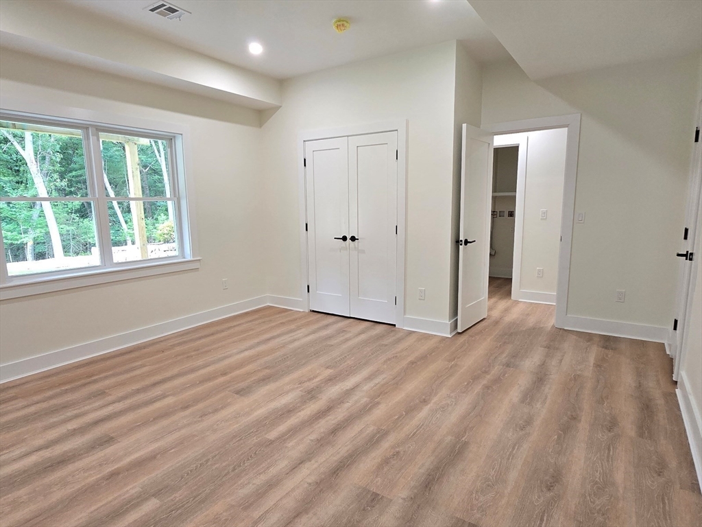 1 Danforth Drive Holliston, MA 01746 - Photo 40 of 42 a view of an empty room with wooden floor and a window
