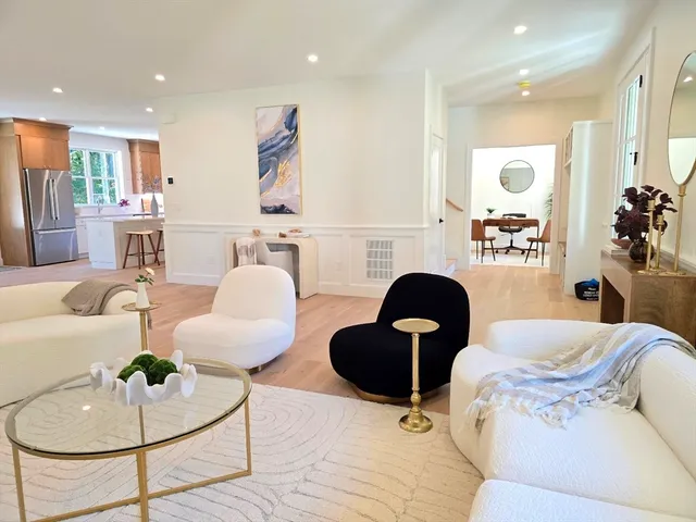 a living room with furniture and kitchen view