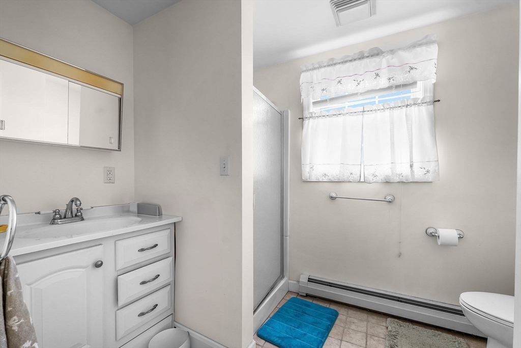 22 12th Road Marshfield, MA 02050 - Photo 13 of 42 a bathroom with a sink a toilet and a window