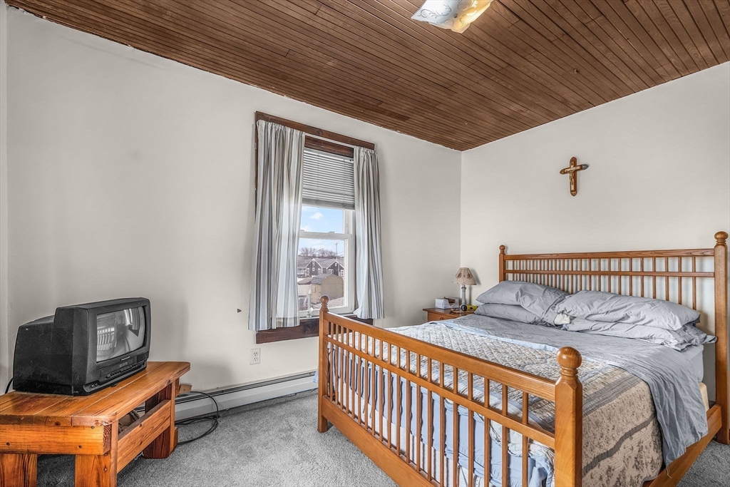 22 12th Road Marshfield, MA 02050 - Photo 17 of 42 a bedroom with a bed and a window