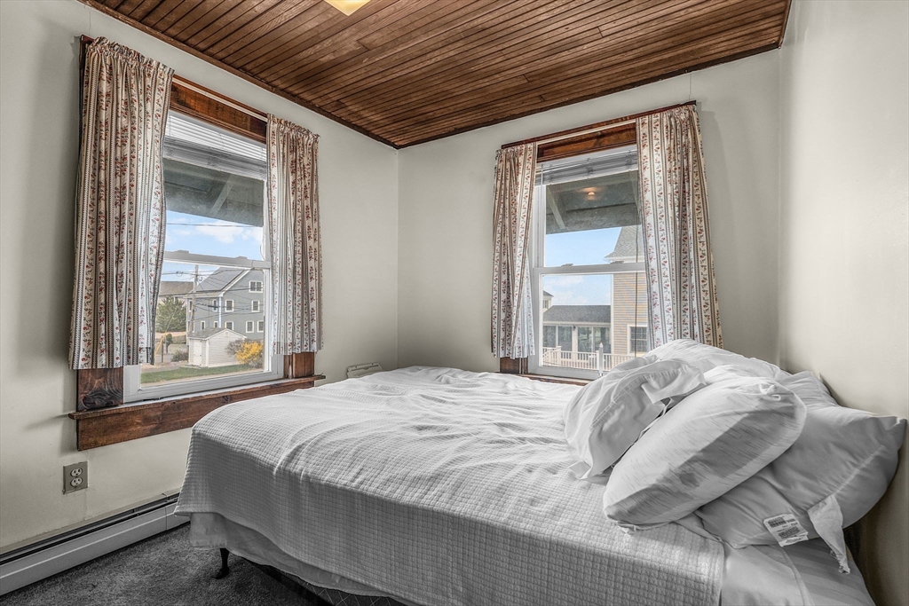 22 12th Road Marshfield, MA 02050 - Photo 18 of 42 a bed sitting in a bedroom next to a window