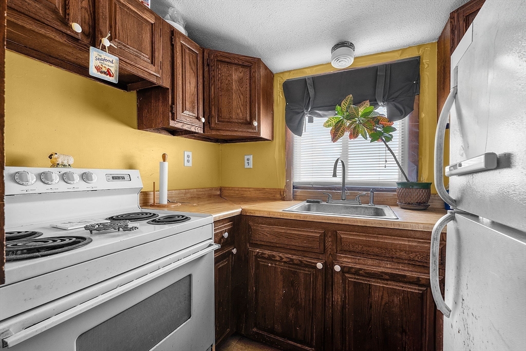 22 12th Road Marshfield, MA 02050 - Photo 24 of 42 a kitchen with stainless steel appliances granite countertop a sink stove and cabinets