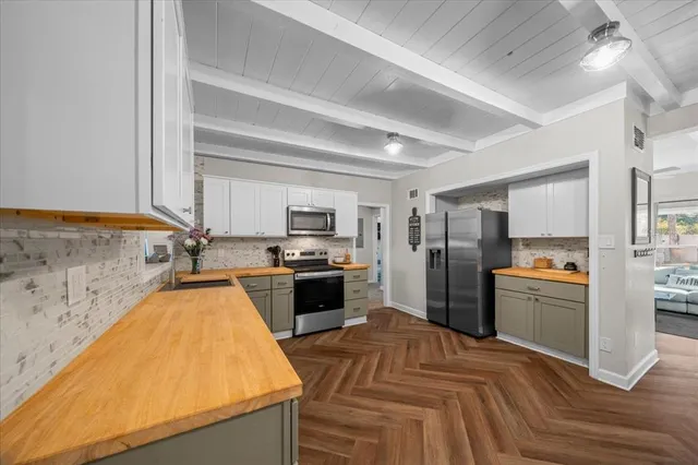 a kitchen with a refrigerator sink and stove top oven