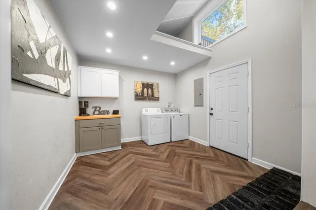a kitchen with a refrigerator and white cabinets