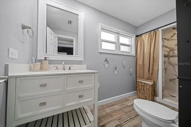a dirty bathroom with white walls